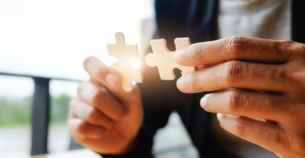 Close-up of a woman trying to solve a puzzle